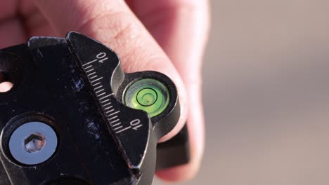 Centering-the-bubble-level-of-a-tripod,-close-up-view