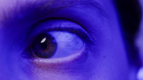 close-up of a person's eye under blue light