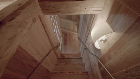 backwards shot of unique wooden stairs of house interior