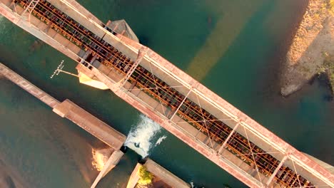 a nice steady overhead view of a dam and bridge that manages water in the dry arid areas of south africa