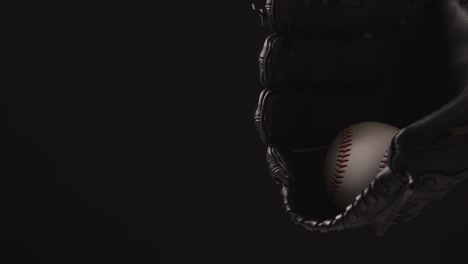 close up baseball shot with baseball ball being thrown and caught in catchers mitt 1