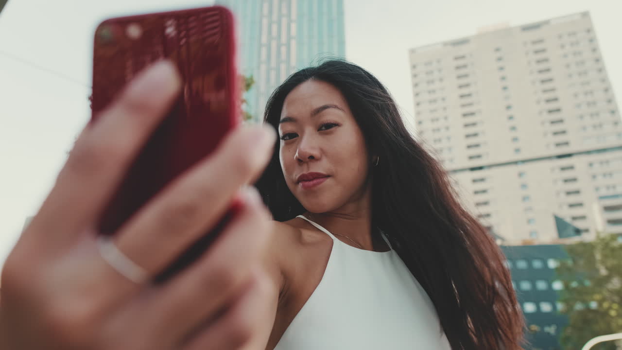 Woman taking a selfie in the city