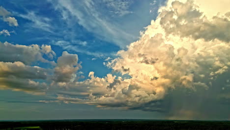 Storm-clouds-lit-by-warm-color-sunshine-flowing-in-the-sky,-time-lapse