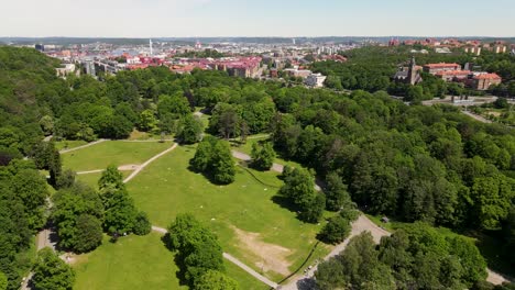 natural forest park with urban landscape at the background during daytime in slottsskogen, göteborg, sweden