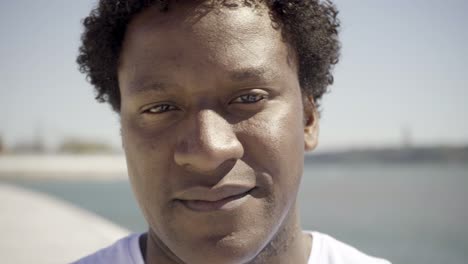 Closeup-shot-of-young-man-looking-at-camera-during-sunny-day