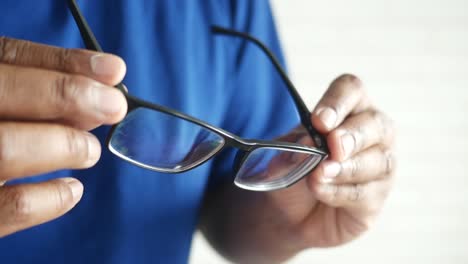 close-up of a man's hands holding glasses