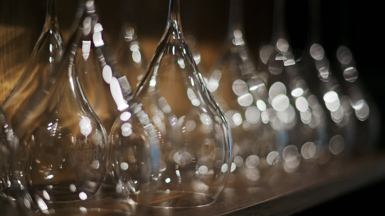 Close up of empty glasses turned upside down on a shelf