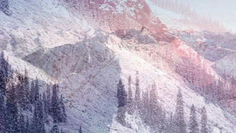 digital composition of glowing spots of light against snow landscape with mountains and trees