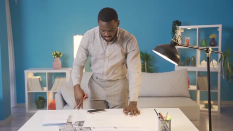 African-man-working-on-project-at-his-home.