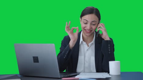 Happy-Indian-female-manager-talking-on-mobile-phone-Green-screen