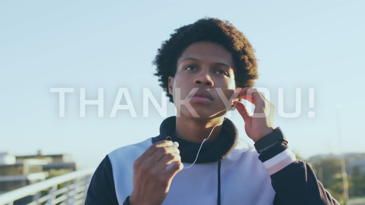Animation of thank you text over biracial male runner wearing earphones