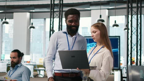 junior dev and colleague in office reviewing ai system metrics