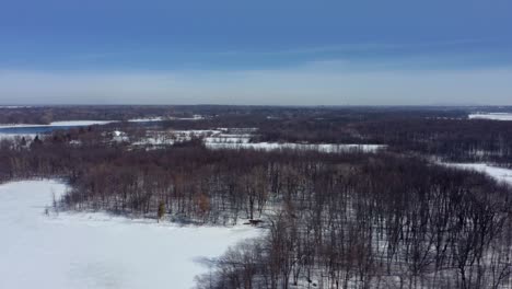 Drone-flying-over-a-park-in-winter-on-a-sunny-day