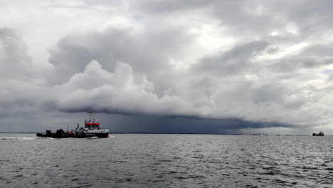 tugboat navigates the choppy waters of the north sea, facing the approaching storm clouds with determination