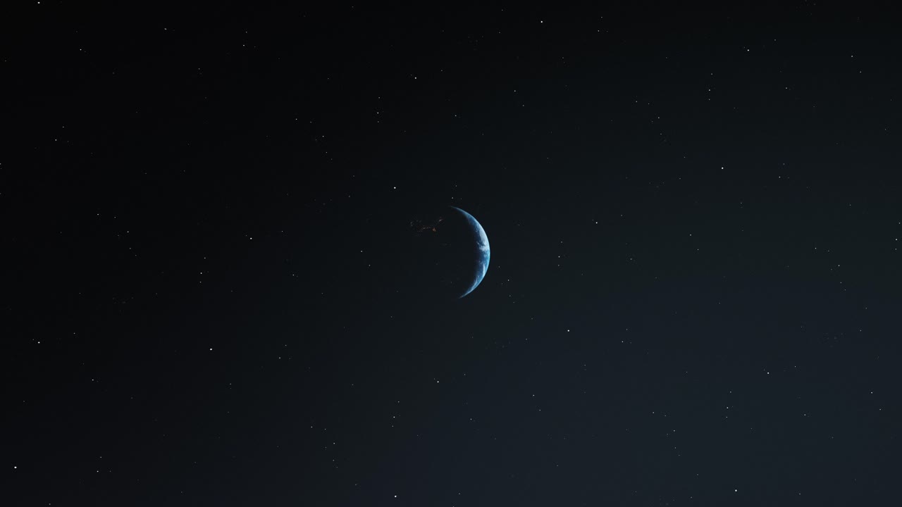 orbitando la tierra y lentamente iluminada contra el cielo oscuro