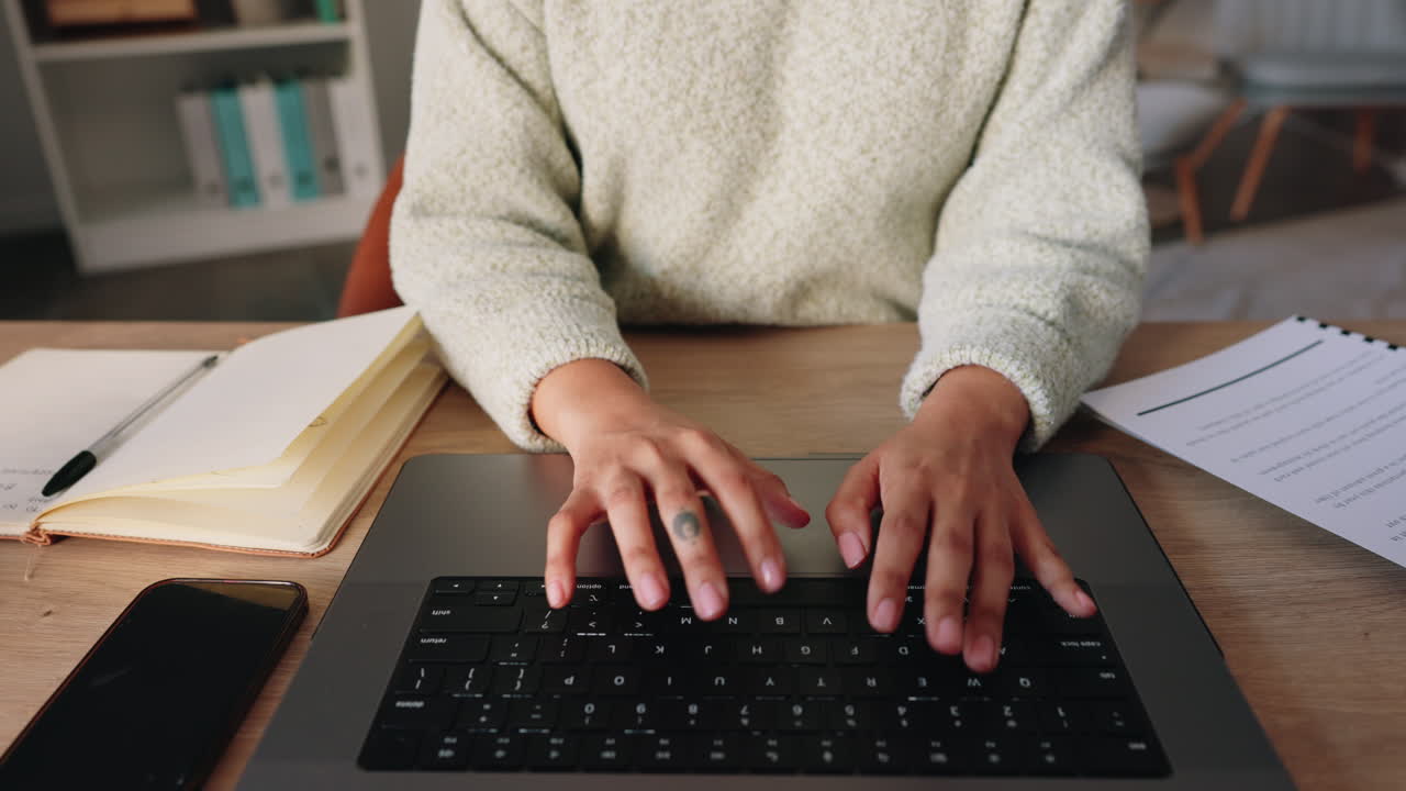 Business woman with hands typing on her laptop