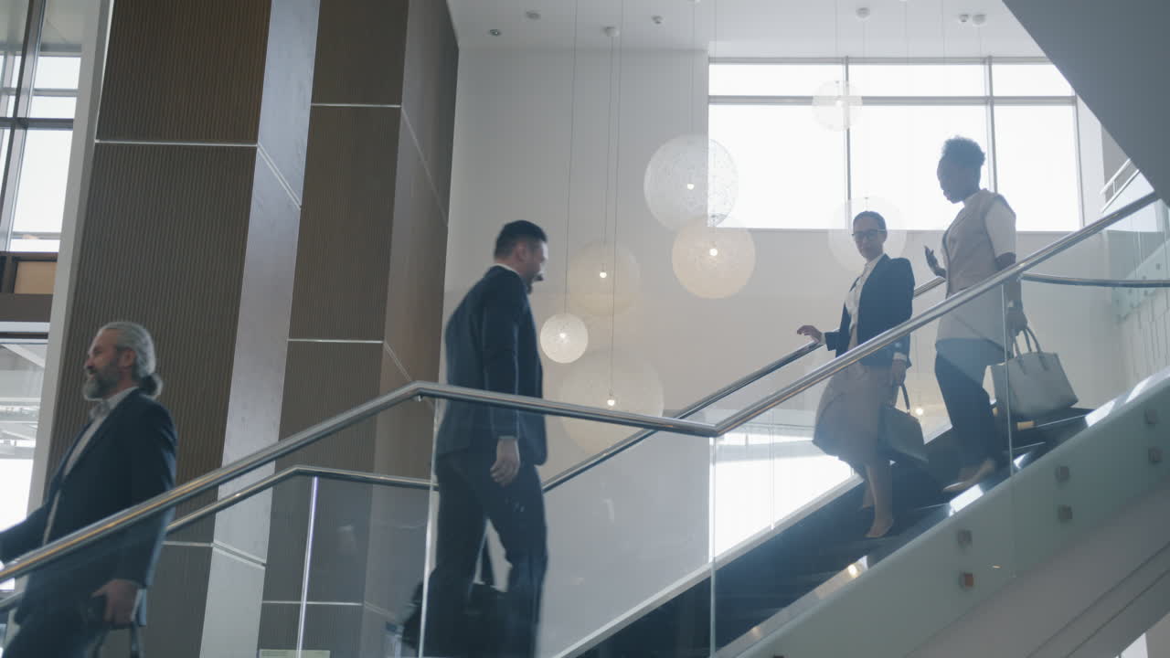 Business People on Escalator in Modern Office Building