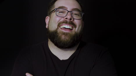 motion studio portrait of a happy bearded man laughing