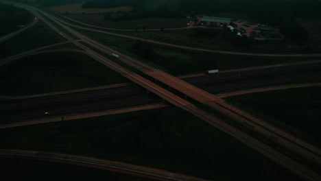 aerial view of a solitary truck navigating a misty highway at night