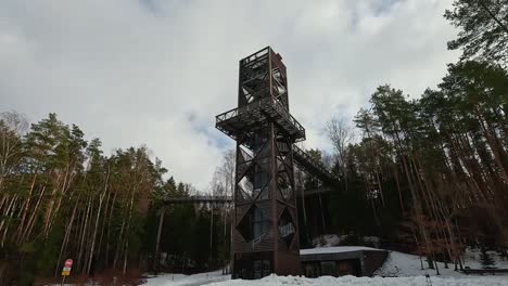 view of anyksciai laju takas, treetop walking path complex with a walkway, an information center and observation tower, located in anyksciai, lithuania near sventoji river