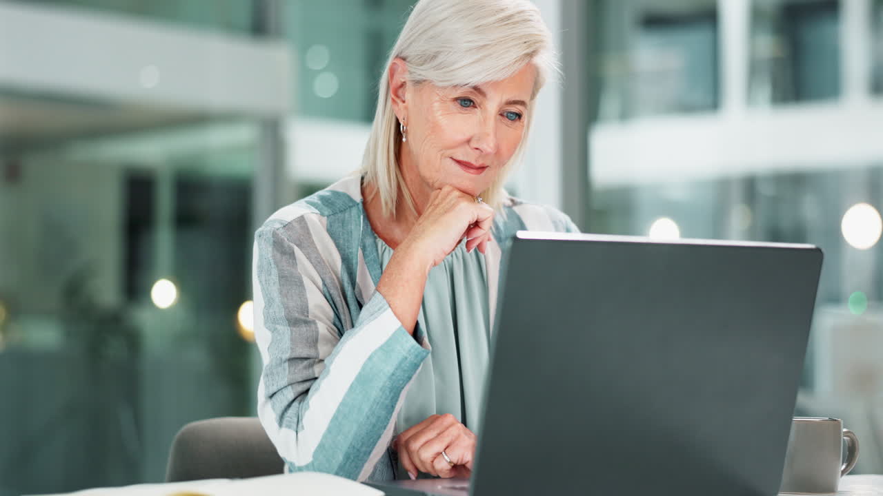 Mature businesswoman working on a laptop in the office