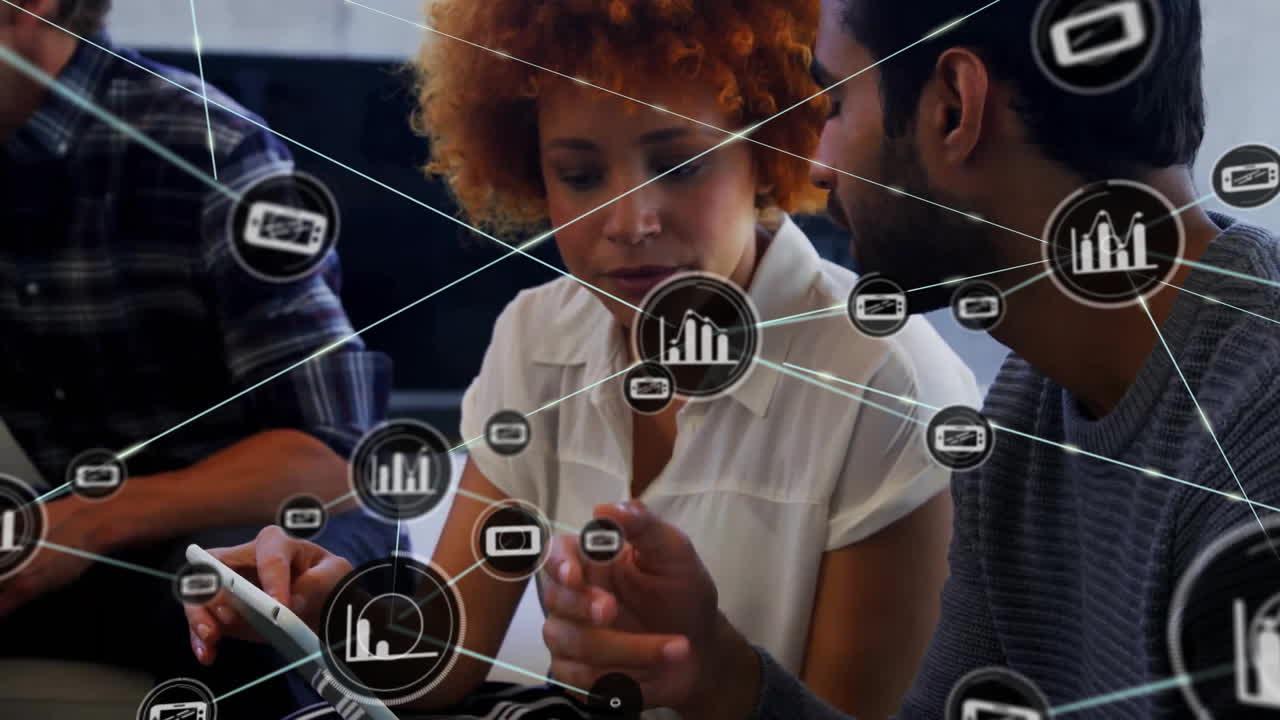 Animation of connected graph and phone icons over diverse colleagues discussing over digital tablet