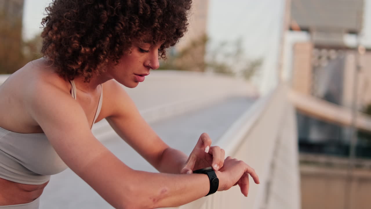 Fit Woman Checks Smartwatch During Workout