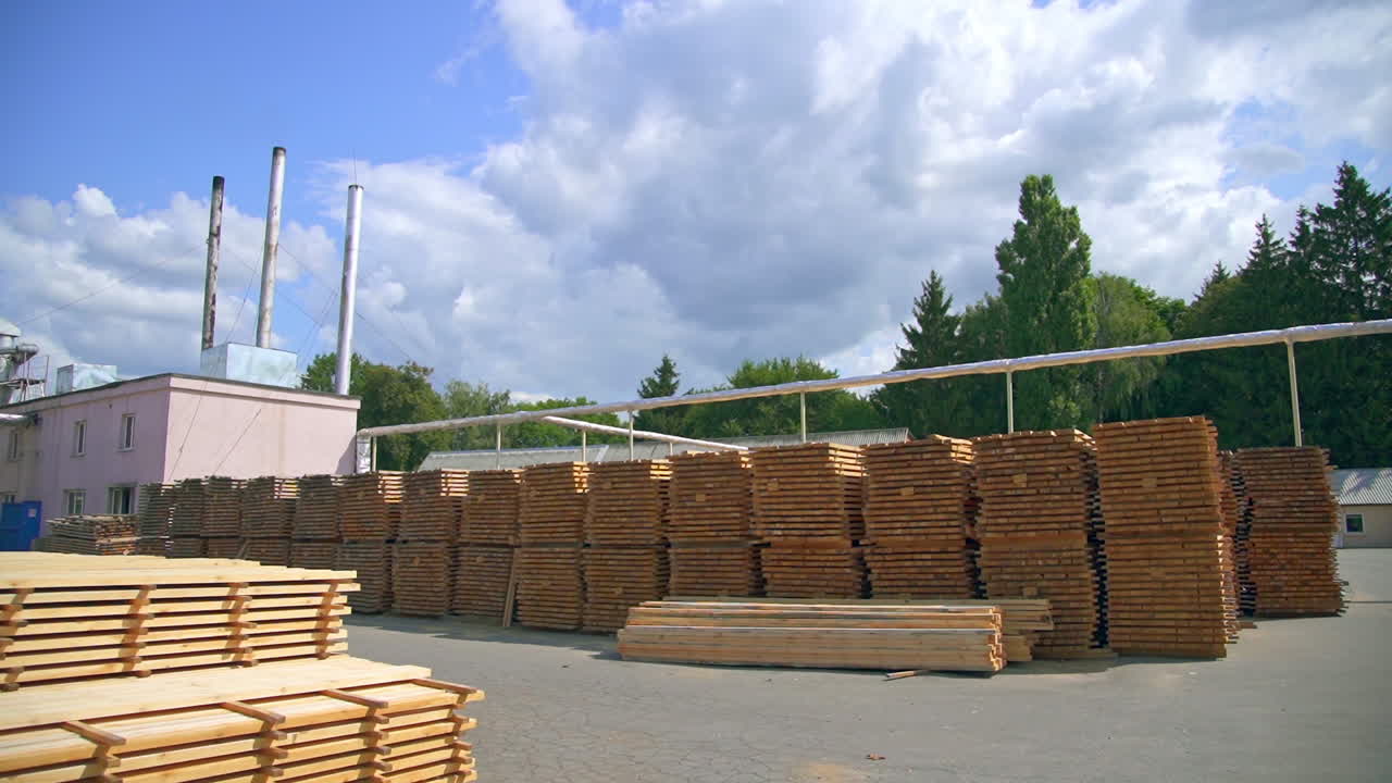 Wooden plank piled outside at the modern plant. Piles of wood for door manufacturing.