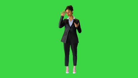 young black businesswoman speaking to the camera on a green screen, chroma key
