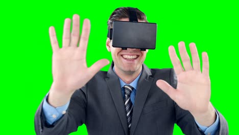 Happy-businessman-using-virtual-reality-headset