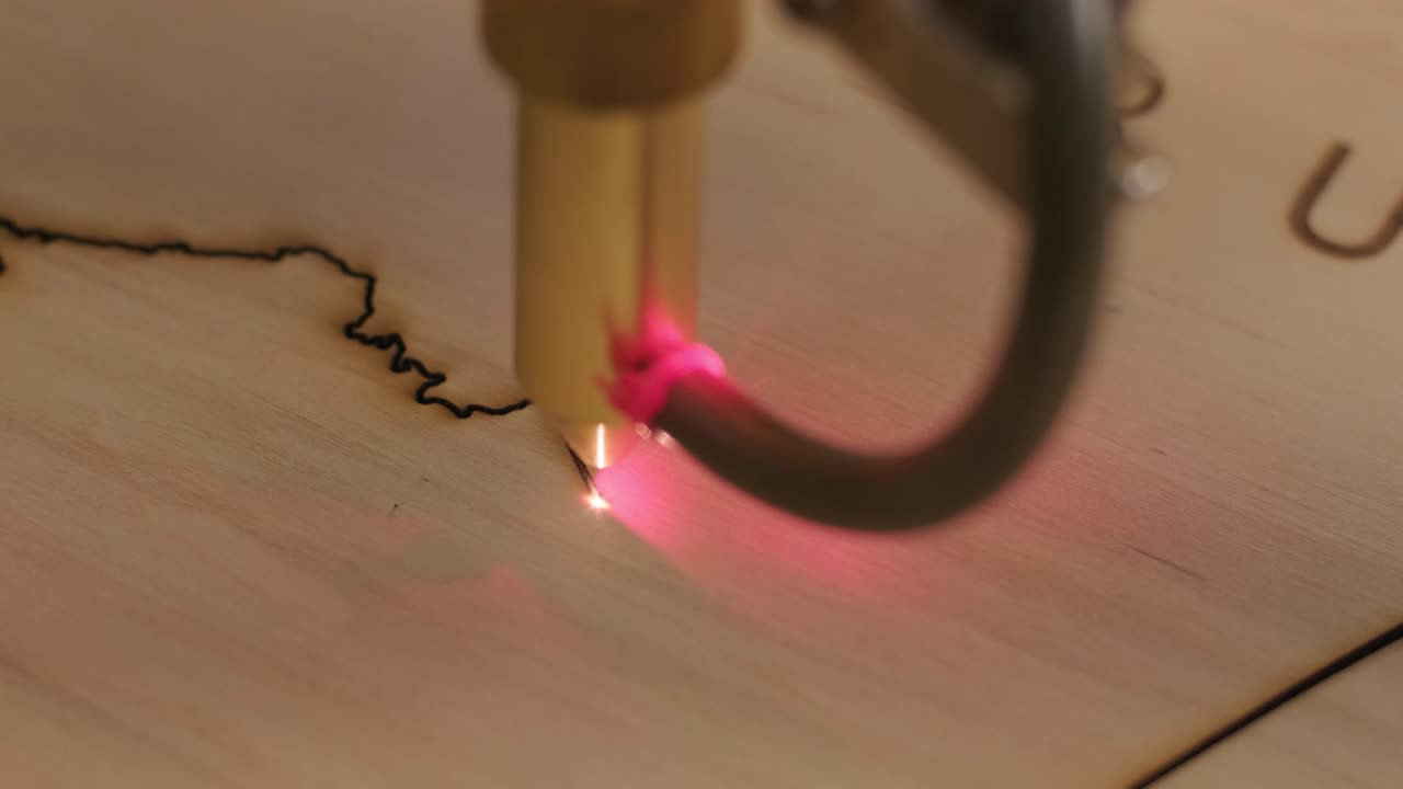 Cnc laser cutting machine cuts wooden plank and plywood