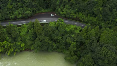 aerial view of car driving through mountain road in saijo, ehime japan