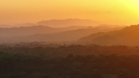 Vibrant-sunset-sky-at-La-Boca-with-mountain-silhouettes-going-to-back,-aerial