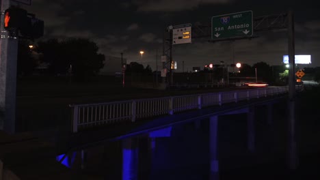 Night-time-lapse-of-traffic-on-entering-freeway-with-San-Antonio-Sign