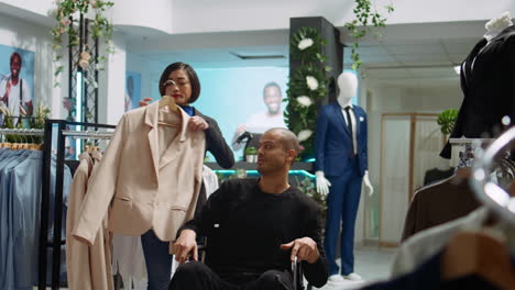 man in wheelchair shopping for clothes