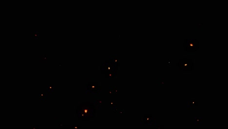 flying glowing fire sparks with an black background