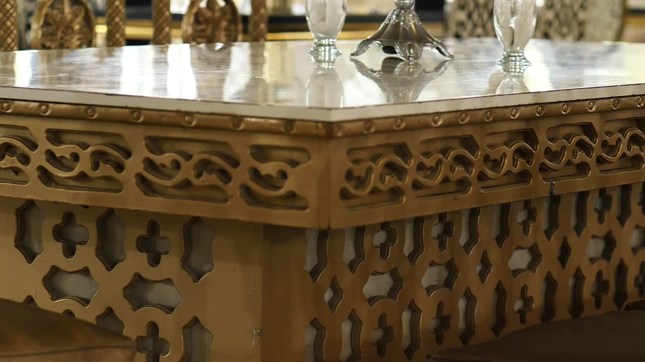 View Of Gold Coloured Corner Table With Carved Designs