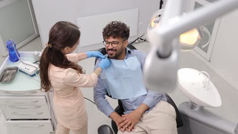 a friendly and inviting dental consultation occurs with a confident patient receiving care from a skilled dentist