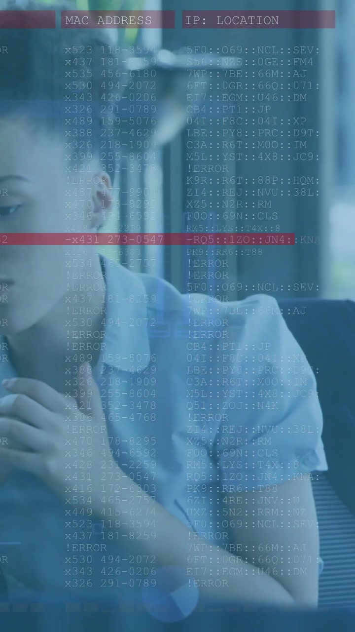 Vertical video: Woman tapping laptop starting tech overlay with MAC or IP and red alert, responding