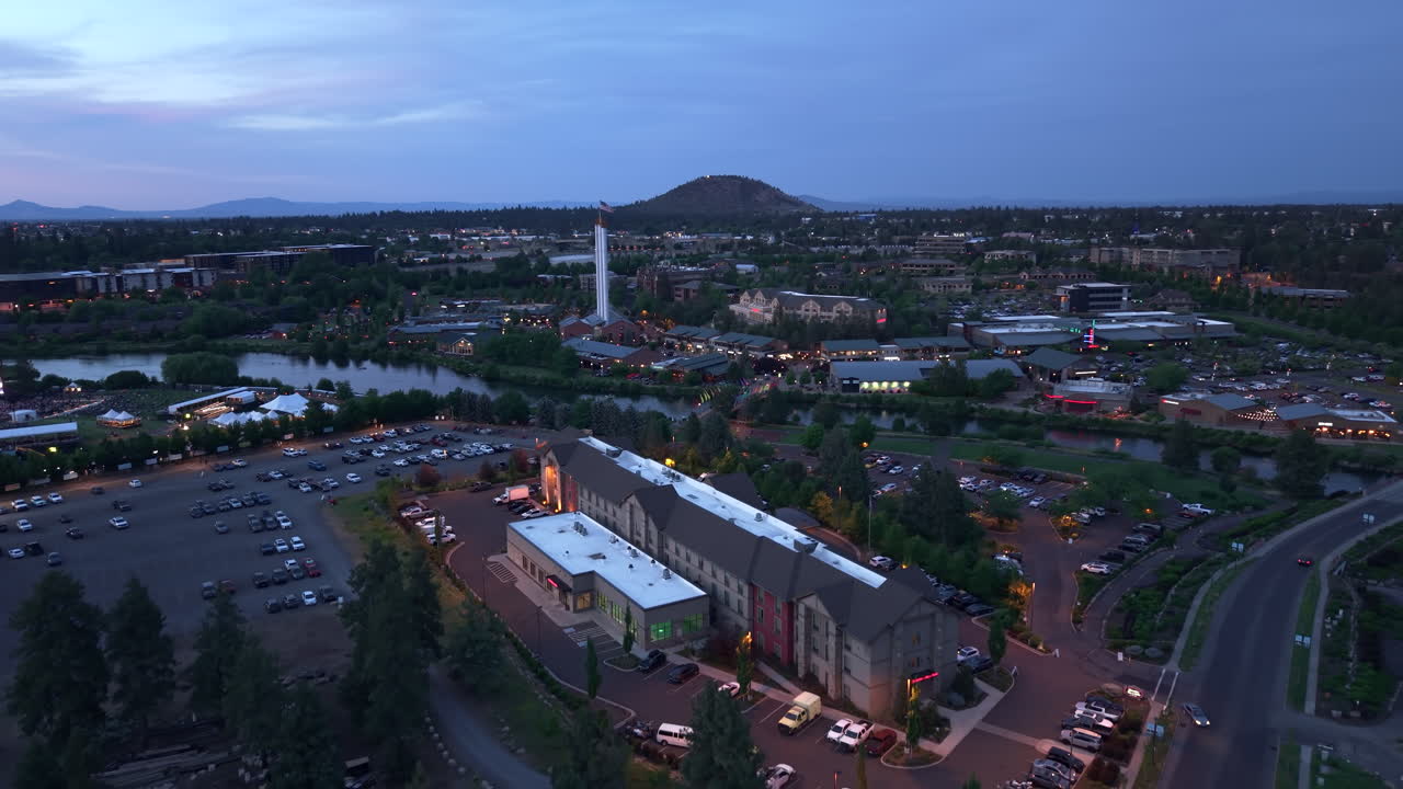Drone rising shot over Hampton Inn Suites in Bend Oregon. Evening blue hour 4k clip.