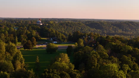aerial view of a park with a ferris wheel at sunset