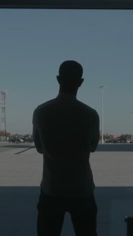 man silhouette at airport parking lot