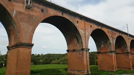 Sweeping-view-of-a-grade-II-listed,-Victorian,-Railway-Viaduct-showing-it-disappearing-into-the-distance-across-fields-on-a-sunny-September-day