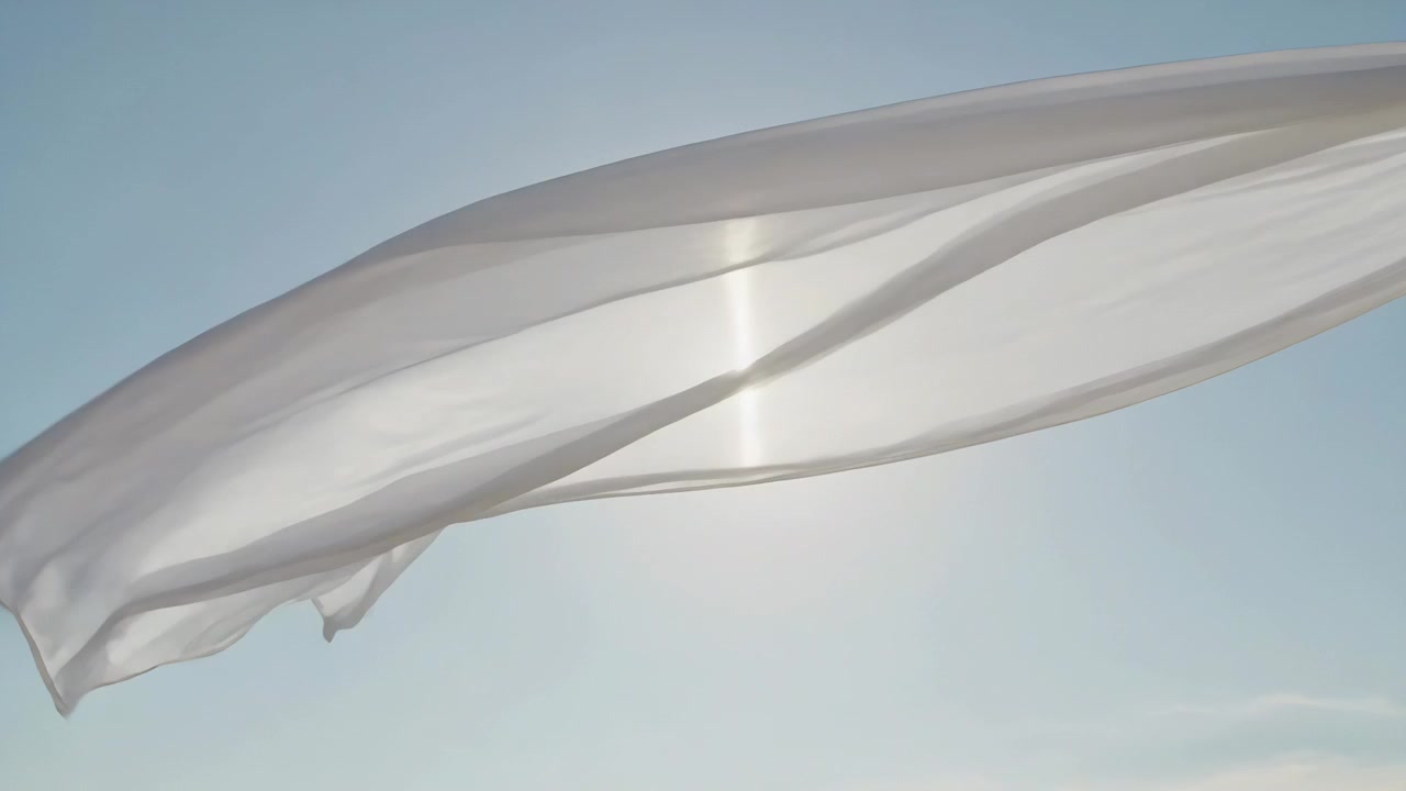 Billowing white thin cloth tied top-right against blue sky, catching wind and revealing sun flare