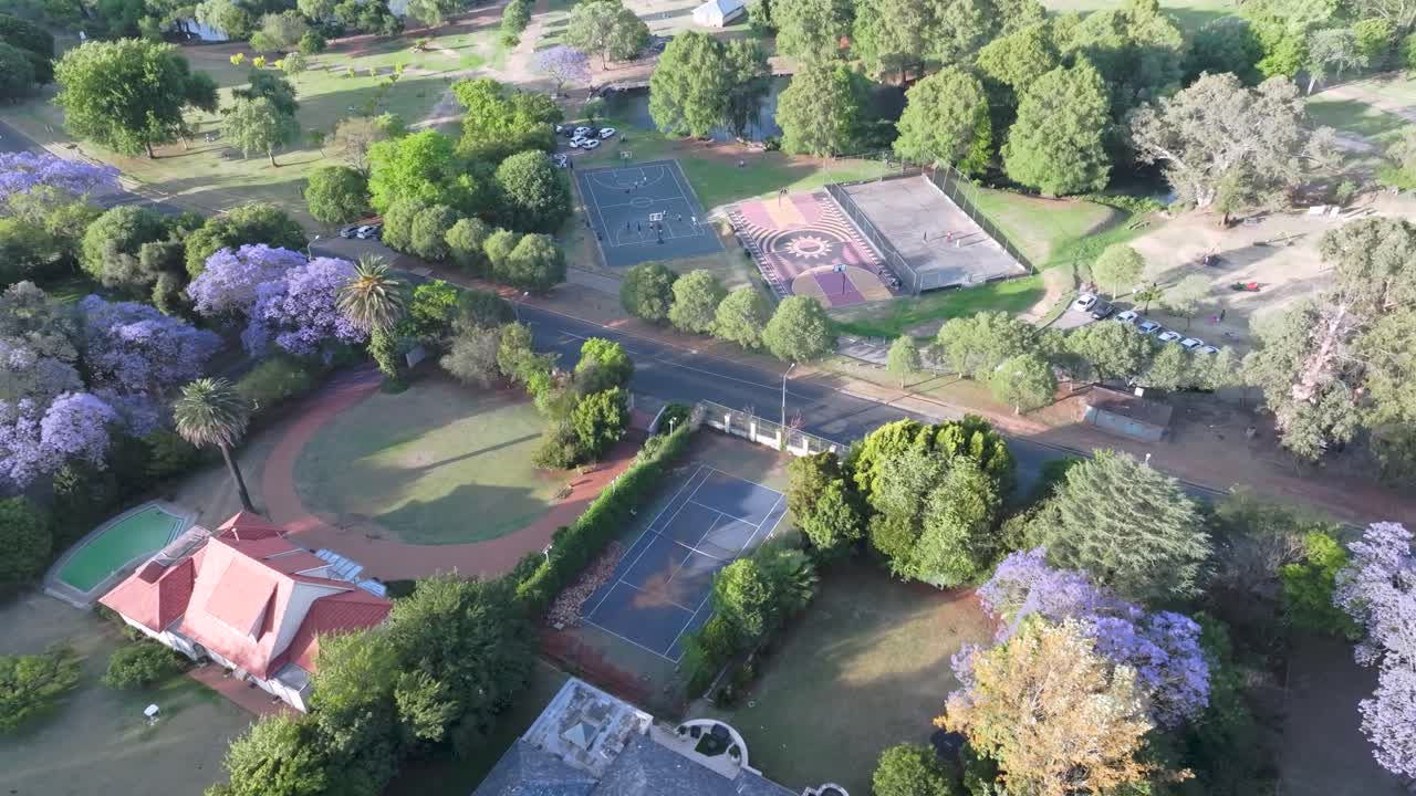Northern sandton showcasing tennis courts and lush greenery in johannesburg, aerial view