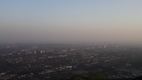 hazy evening view over islamabad with urban sprawl and distant high-rises. islamabad, pakistan