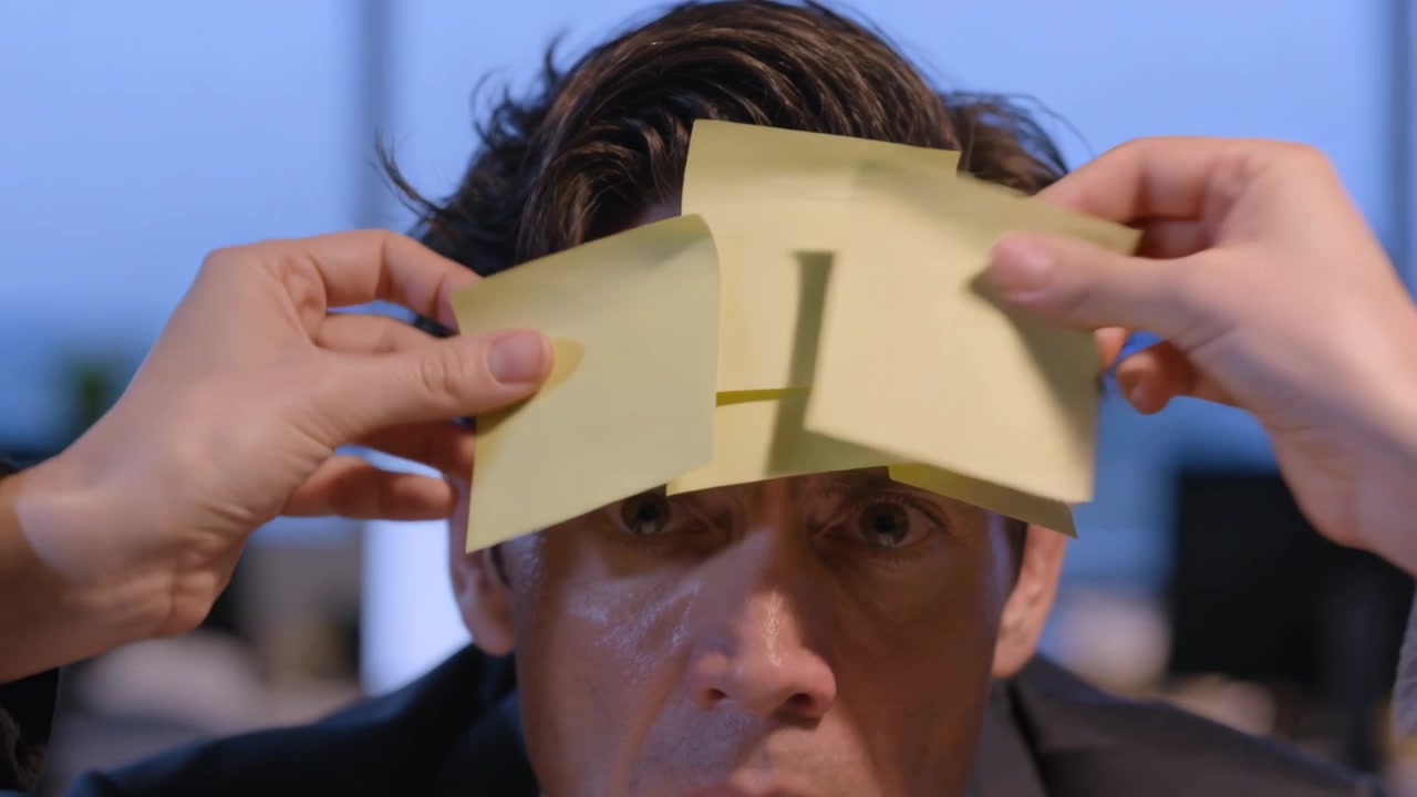 Receiving man in suit and tie at office, widening eyes as hands placing yellow sticky notes