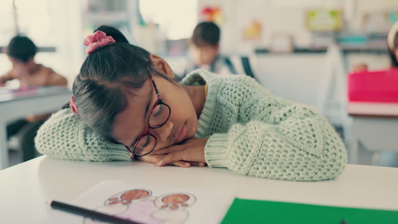 Tired, sleeping and kid at desk in classroom