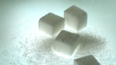 sugar cube falling onto pile of cubes and powder sugar