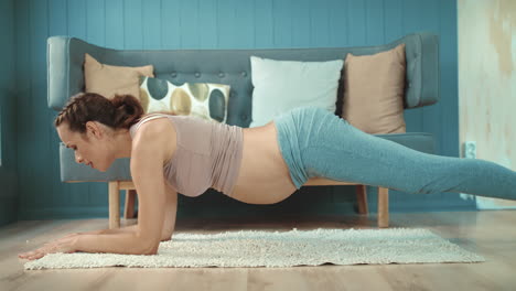 closeup pregnant belly mother practicing yoga exercise at home.